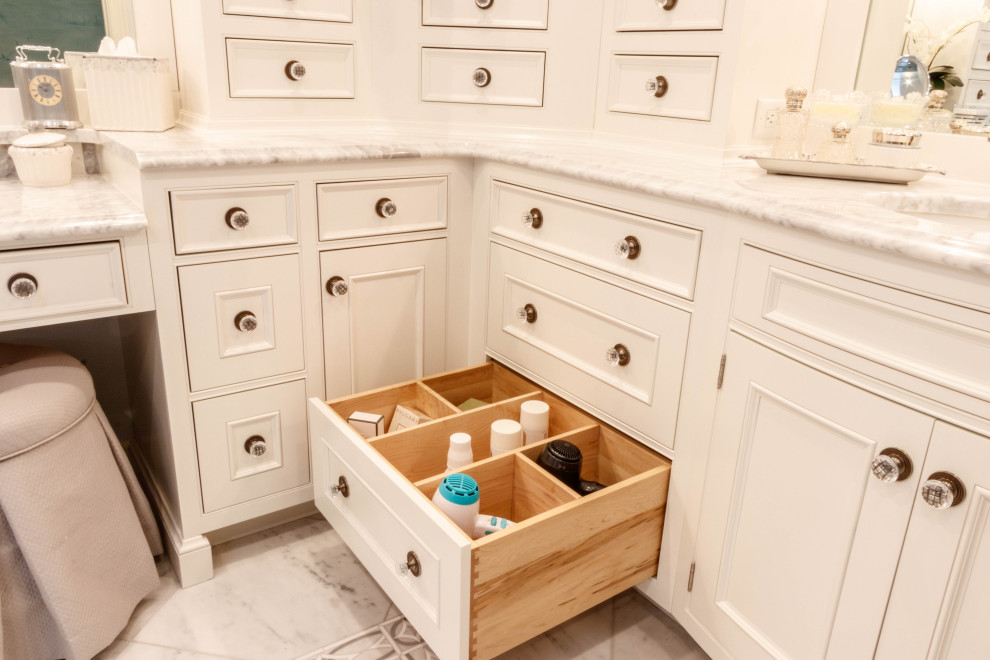 This is an example of a large classic ensuite bathroom in St Louis with freestanding cabinets, white cabinets, a freestanding bath, an alcove shower, a one-piece toilet, white tiles, marble tiles, blue walls, marble flooring, a submerged sink, marble worktops, white floors, a hinged door, white worktops, an enclosed toilet, double sinks, a built in vanity unit and wallpapered walls.