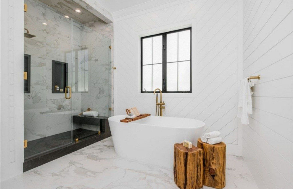 Example of a large minimalist master white tile and marble tile marble floor and white floor corner shower design in Los Angeles with flat-panel cabinets, white cabinets, a one-piece toilet, white walls, an integrated sink, tile countertops, a hinged shower door and black countertops