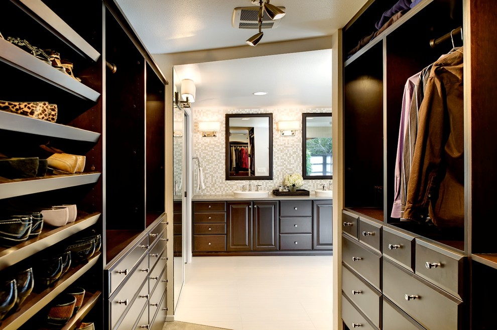 Closet - large contemporary ceramic tile closet idea in Portland with raised-panel cabinets and dark wood cabinets