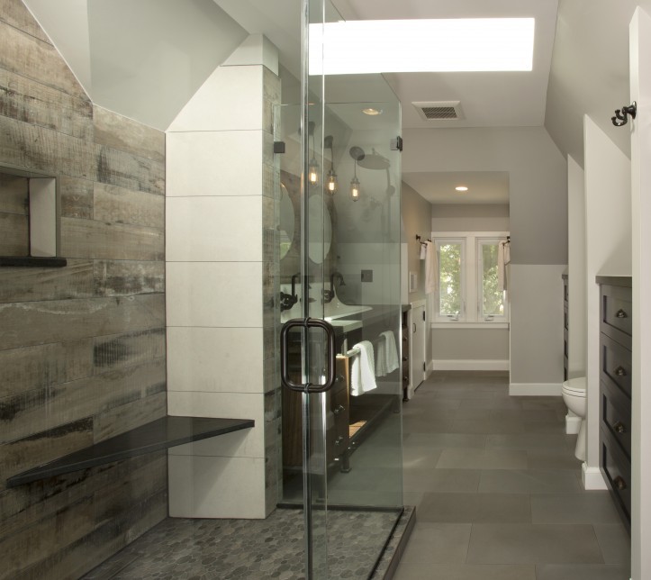 Inspiration for a large industrial master gray tile and porcelain tile porcelain tile and gray floor doorless shower remodel in DC Metro with a trough sink, dark wood cabinets, solid surface countertops, gray walls, open cabinets, a two-piece toilet and a hinged shower door
