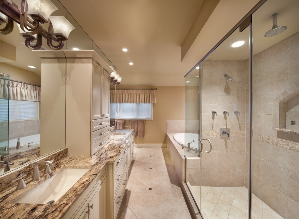 Example of a large trendy master ceramic tile and beige floor bathroom design in DC Metro with recessed-panel cabinets, beige cabinets, beige walls, an undermount sink, granite countertops and a hinged shower door
