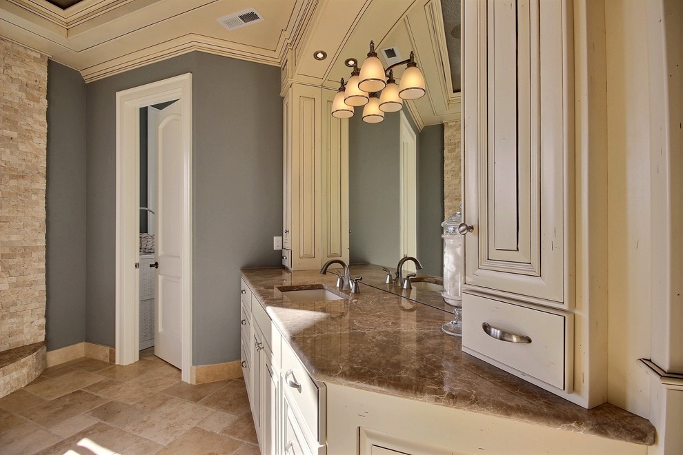 Inspiration for a huge timeless master beige tile and stone slab travertine floor bathroom remodel in Portland with raised-panel cabinets, beige cabinets, blue walls, an undermount sink and marble countertops