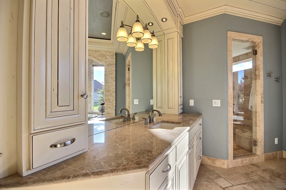 Inspiration for a huge transitional master beige tile and stone slab travertine floor bathroom remodel in Portland with raised-panel cabinets, beige cabinets, blue walls, an undermount sink and marble countertops
