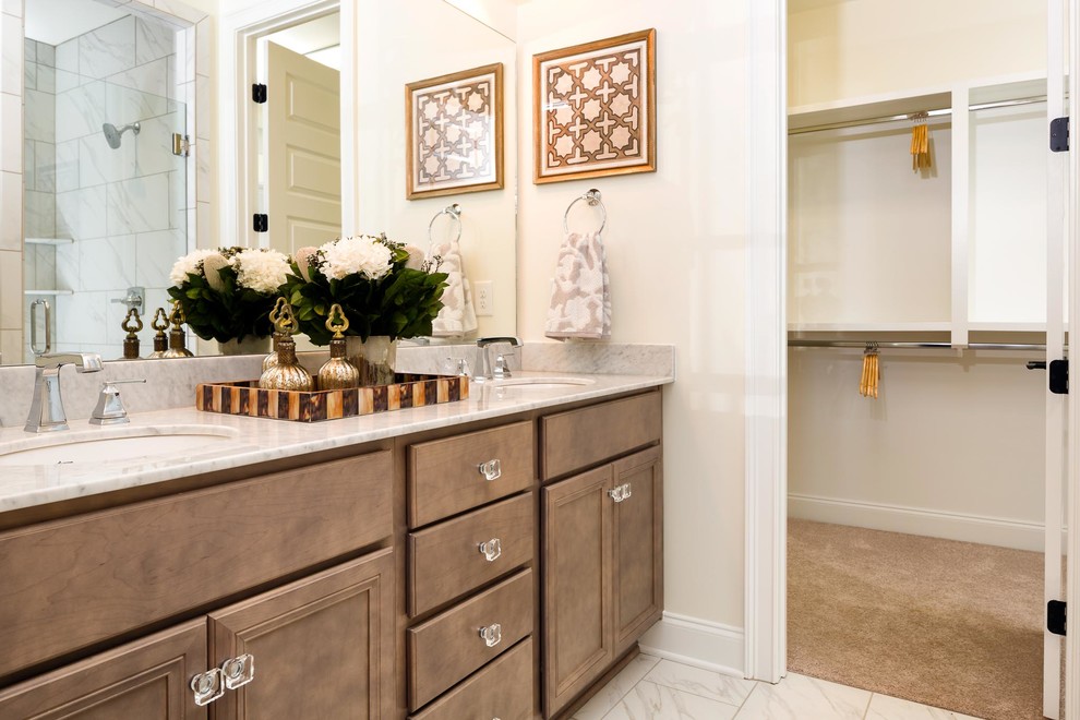 Example of a mid-sized classic master beige tile and ceramic tile ceramic tile alcove shower design in Nashville with louvered cabinets, brown cabinets, a two-piece toilet, white walls, an undermount sink and quartz countertops
