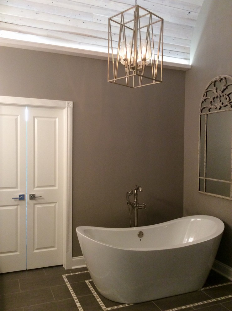 Inspiration for a large traditional ensuite bathroom in New Orleans with shaker cabinets, white cabinets, a freestanding bath, an alcove shower, a two-piece toilet, grey tiles, porcelain tiles, grey walls, porcelain flooring, a submerged sink, granite worktops, grey floors and an open shower.