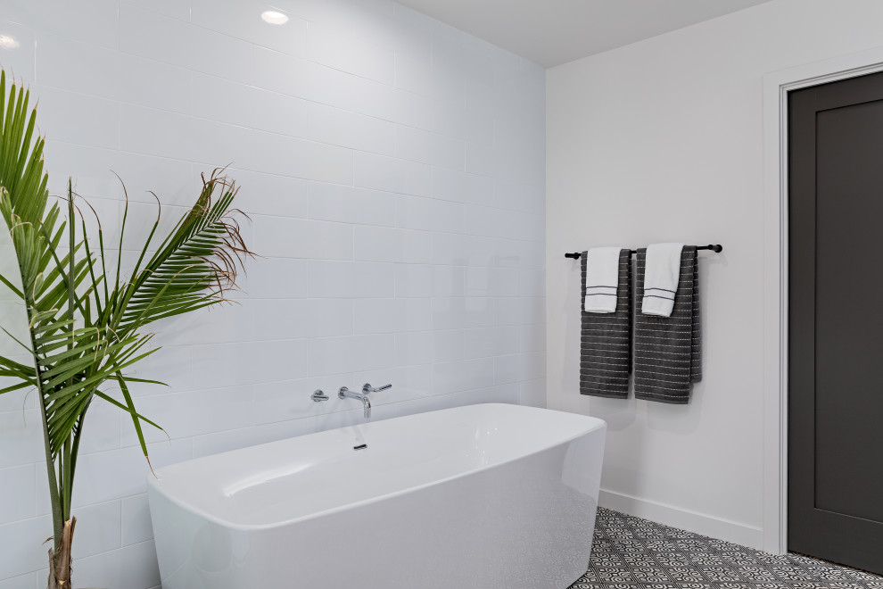This is an example of a medium sized modern ensuite bathroom in Los Angeles with a freestanding bath, an alcove shower, white walls, porcelain flooring and white floors.