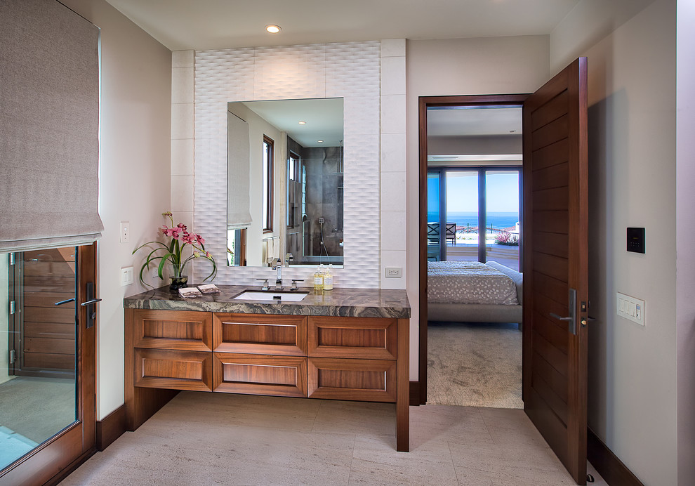 Inspiration for a large contemporary ensuite bathroom in Orange County with a submerged sink, shaker cabinets, medium wood cabinets, a freestanding bath, a corner shower, beige tiles, stone tiles, beige walls, limestone flooring and marble worktops.