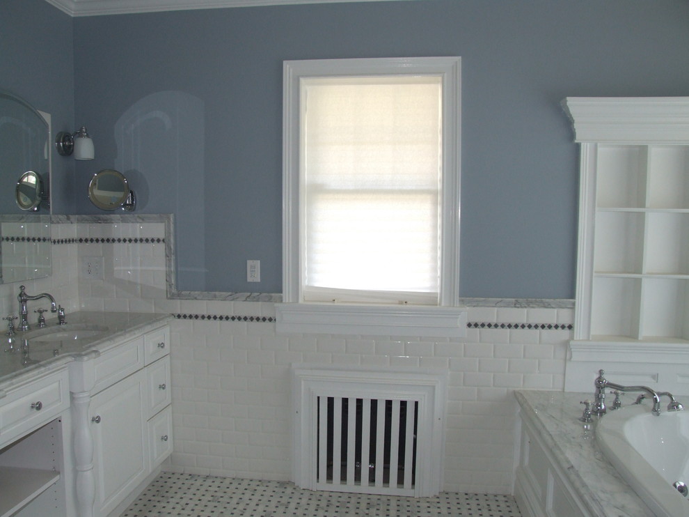 Inspiration for a large timeless master white tile and subway tile marble floor bathroom remodel in New York with an undermount sink, marble countertops, raised-panel cabinets, white cabinets, a two-piece toilet and blue walls
