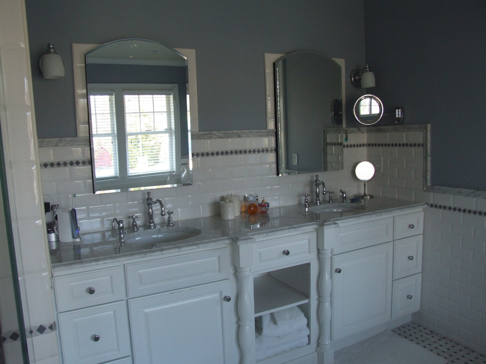 Example of a large classic master white tile and subway tile marble floor bathroom design in New York with an undermount sink, marble countertops, raised-panel cabinets, white cabinets, a two-piece toilet and blue walls