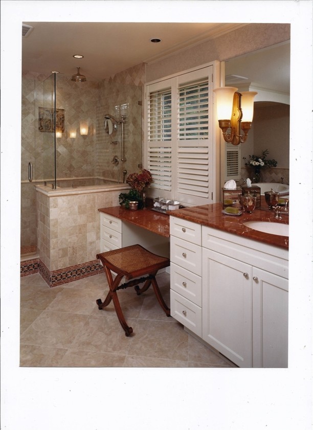 Example of a classic beige tile and stone tile marble floor bathroom design in New York with marble countertops