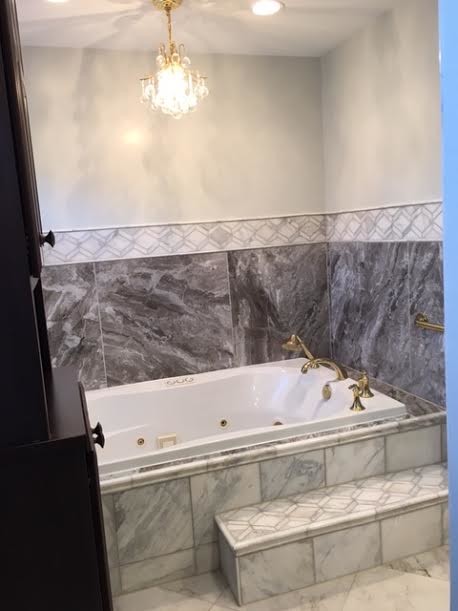 Inspiration for a mid-sized transitional master multicolored tile and stone slab marble floor and multicolored floor bathroom remodel in DC Metro with raised-panel cabinets, dark wood cabinets, a two-piece toilet, white walls, a vessel sink and quartz countertops