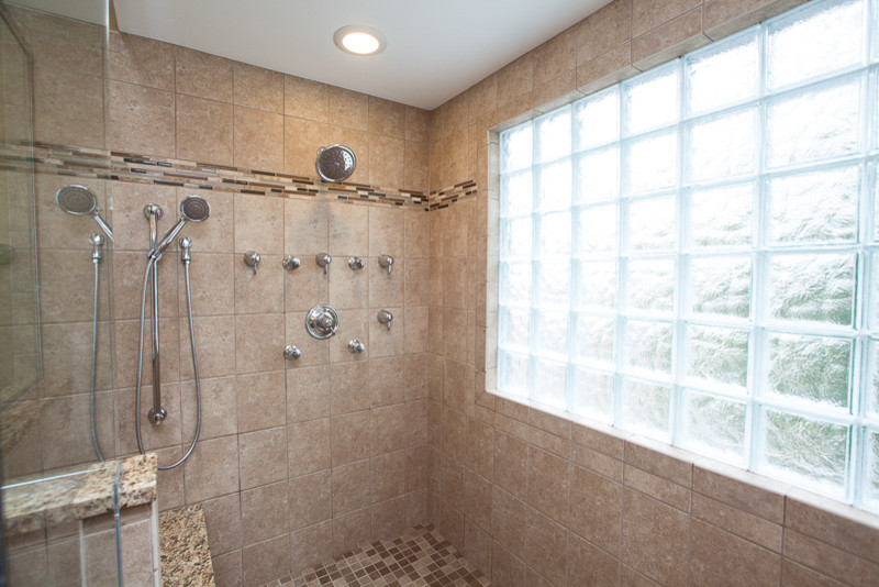 Inspiration for a huge timeless master beige tile and stone tile travertine floor alcove shower remodel in Other with granite countertops, a two-piece toilet, shaker cabinets, medium tone wood cabinets, beige walls and an undermount sink