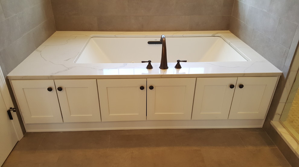Medium sized traditional ensuite bathroom in Boston with shaker cabinets, white cabinets, a built-in bath, porcelain flooring, a submerged sink, engineered stone worktops, grey floors and multi-coloured worktops.