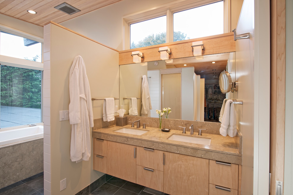 Inspiration for a large contemporary master white tile and ceramic tile slate floor bathroom remodel in Seattle with an undermount sink, flat-panel cabinets, light wood cabinets, limestone countertops, a two-piece toilet and beige walls