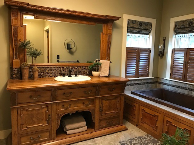 Mid-sized elegant master gray tile ceramic tile and beige floor drop-in bathtub photo in Portland Maine with furniture-like cabinets, medium tone wood cabinets, beige walls, a drop-in sink and wood countertops