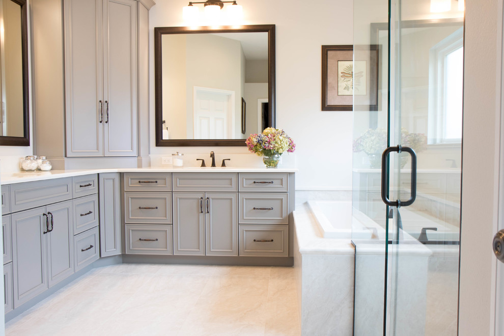 Design ideas for a large traditional ensuite bathroom with recessed-panel cabinets, grey cabinets, grey walls, porcelain flooring, a submerged sink, quartz worktops, grey floors and white worktops.
