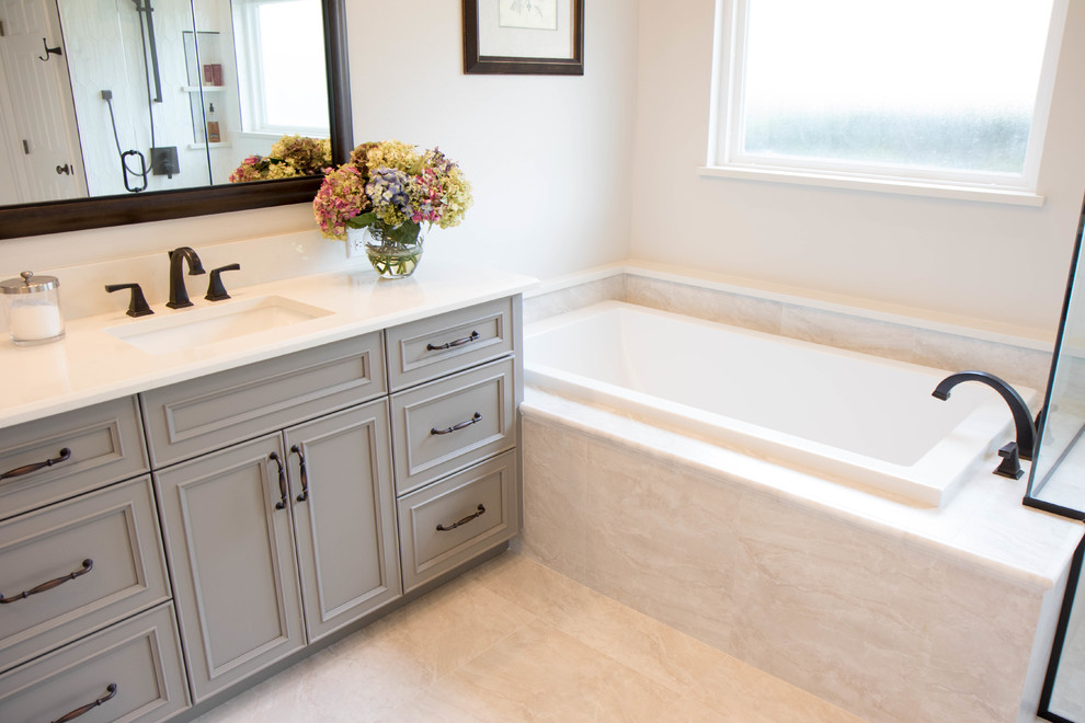 Inspiration for a large classic ensuite bathroom in Orlando with recessed-panel cabinets, grey cabinets, grey walls, porcelain flooring, a submerged sink, quartz worktops, grey floors, white worktops and a built-in bath.