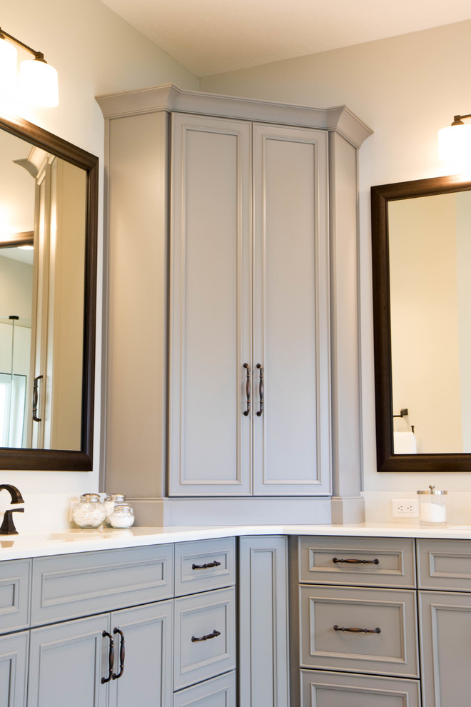 Inspiration for a large traditional ensuite bathroom with recessed-panel cabinets, grey cabinets, grey walls, porcelain flooring, a submerged sink, quartz worktops, grey floors and white worktops.