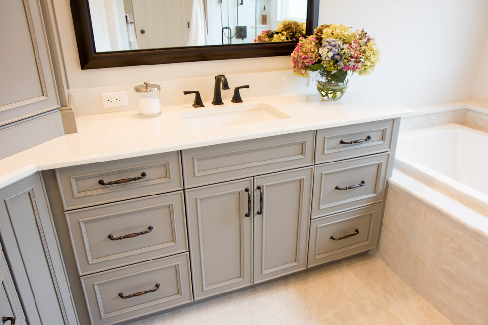 Inspiration for a large classic ensuite bathroom in Orlando with recessed-panel cabinets, grey cabinets, grey walls, porcelain flooring, a submerged sink, quartz worktops, grey floors and white worktops.