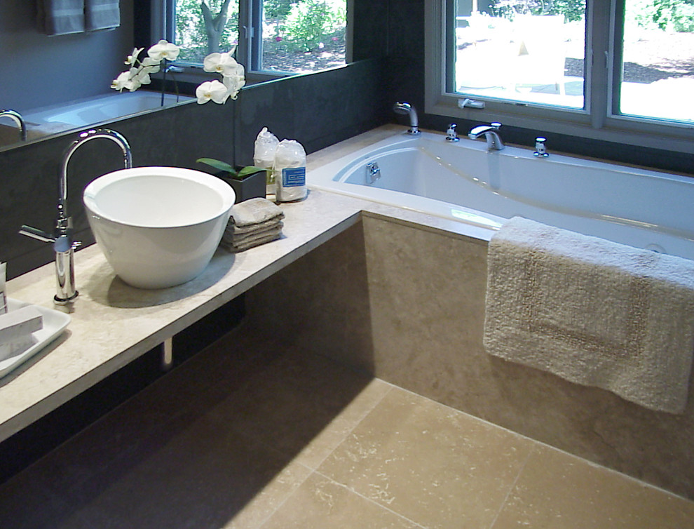Esempio di una stanza da bagno padronale moderna di medie dimensioni con vasca da incasso, piastrelle beige, piastrelle in pietra, pareti marroni, pavimento in travertino, lavabo a bacinella e top in marmo