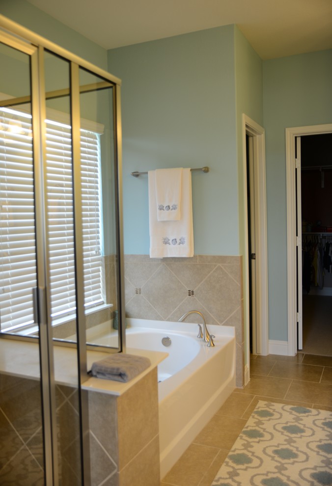 Design ideas for a large beach style ensuite bathroom in Austin with raised-panel cabinets, white cabinets, a hot tub, a double shower, a one-piece toilet, beige tiles, ceramic tiles, blue walls, ceramic flooring, a built-in sink and granite worktops.