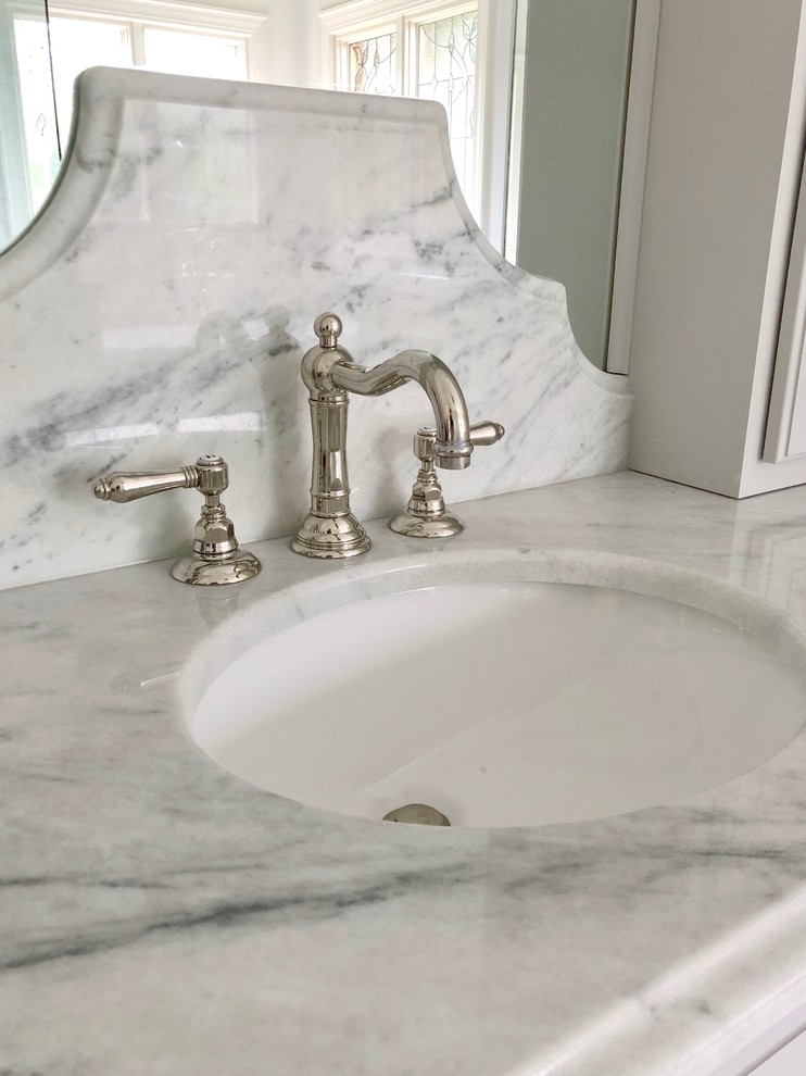 Example of a large classic master gray tile marble floor and gray floor bathroom design in San Francisco with louvered cabinets, gray cabinets, a one-piece toilet, white walls, an undermount sink, marble countertops, a hinged shower door and gray countertops