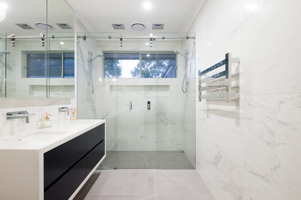 Mid-sized minimalist master gray tile and ceramic tile ceramic tile double shower photo in Sydney with flat-panel cabinets, black cabinets, multicolored walls, an undermount sink and granite countertops