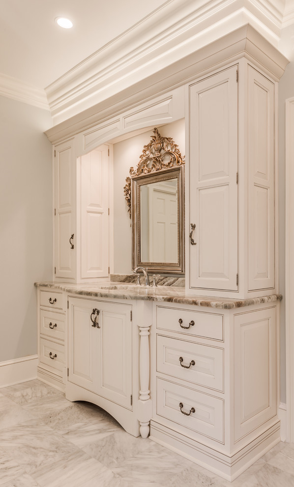 Example of a large classic master white tile and stone tile marble floor bathroom design in Jacksonville with beaded inset cabinets, white cabinets, blue walls, granite countertops and an undermount sink