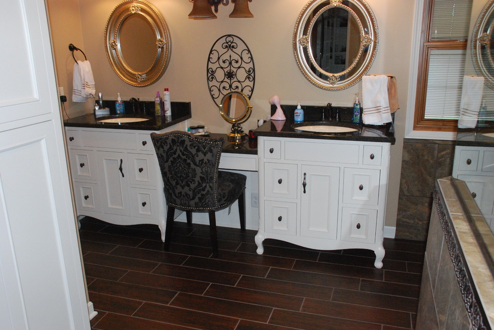 Inspiration for a large timeless master brown tile and ceramic tile ceramic tile bathroom remodel in Cleveland with a vessel sink, furniture-like cabinets, white cabinets, granite countertops, a two-piece toilet and beige walls