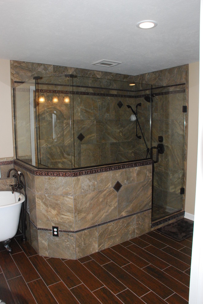 Example of a large classic master brown tile and ceramic tile ceramic tile bathroom design in Cleveland with a vessel sink, white cabinets, granite countertops, beige walls, recessed-panel cabinets and a two-piece toilet