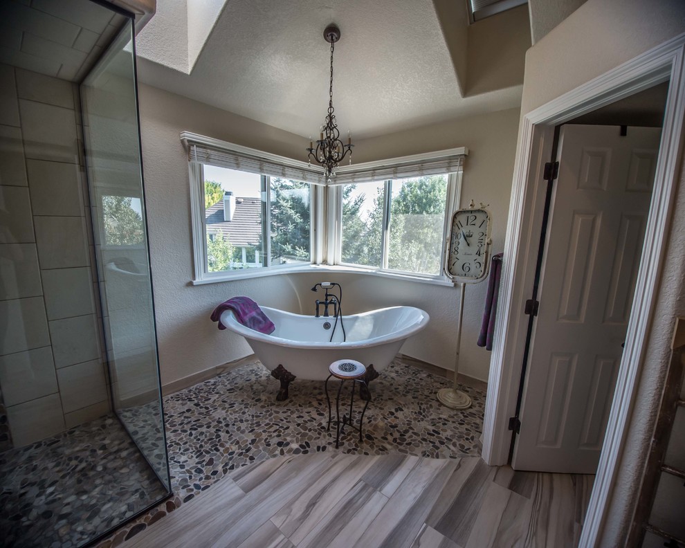 This is an example of a large traditional ensuite bathroom in Denver with raised-panel cabinets, light wood cabinets, a claw-foot bath, a double shower, a one-piece toilet, brown tiles, porcelain tiles, beige walls, porcelain flooring, a wall-mounted sink and marble worktops.