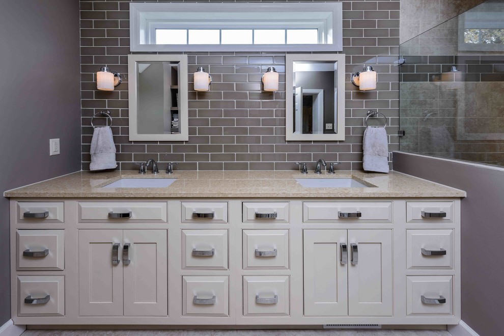 Example of a mid-sized classic master beige tile and subway tile ceramic tile and beige floor alcove shower design in Other with raised-panel cabinets, beige cabinets, a two-piece toilet, gray walls, an undermount sink and quartz countertops