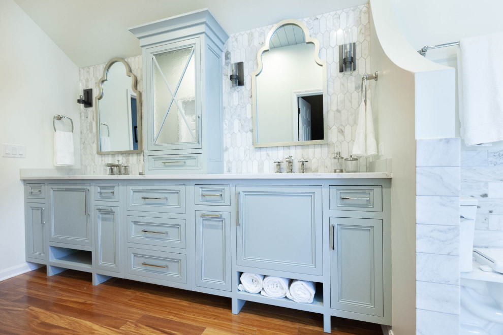 Example of a large classic master porcelain tile and white floor bathroom design in Chicago with beaded inset cabinets, blue cabinets, a two-piece toilet, white walls, an undermount sink, quartz countertops, a hinged shower door and white countertops