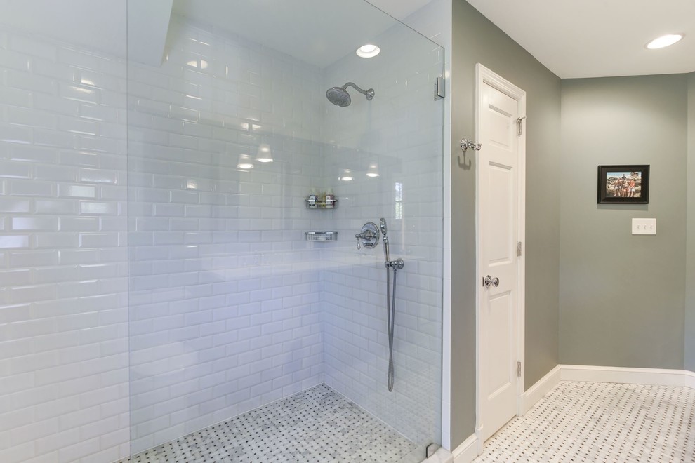 Large elegant master white tile and subway tile mosaic tile floor and multicolored floor bathroom photo in DC Metro with raised-panel cabinets, dark wood cabinets, a two-piece toilet, white walls, an undermount sink and marble countertops