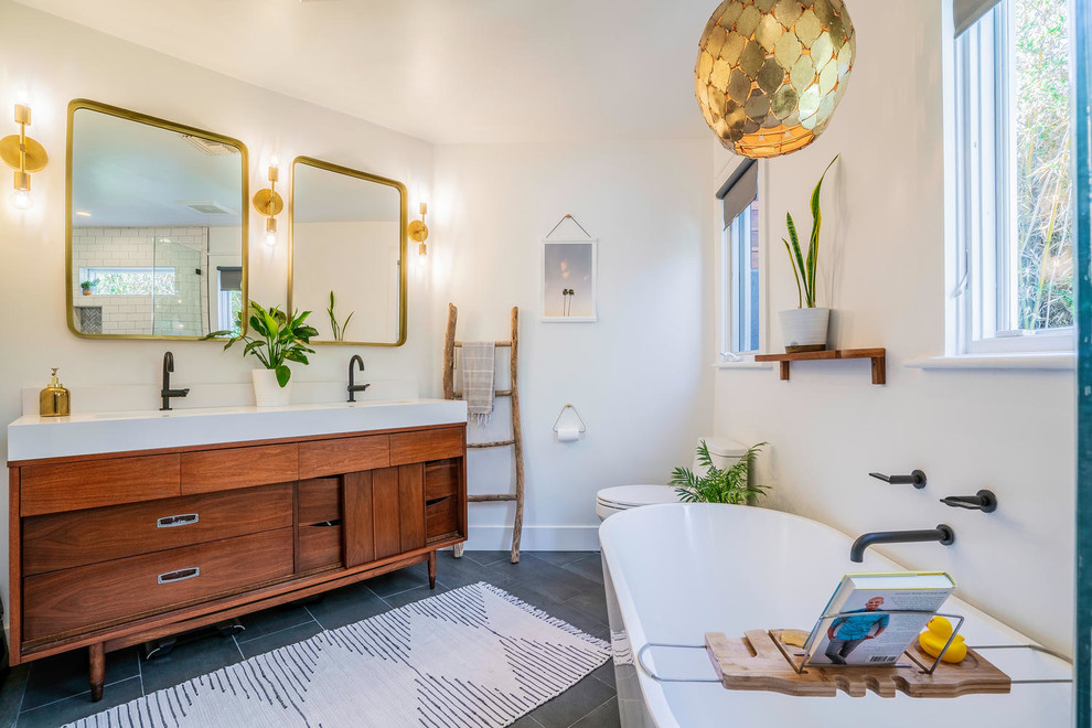 Inspiration for a small eclectic master white tile and ceramic tile ceramic tile and gray floor bathroom remodel in Los Angeles with furniture-like cabinets, brown cabinets, a one-piece toilet, white walls, an undermount sink, quartz countertops, a hinged shower door and white countertops