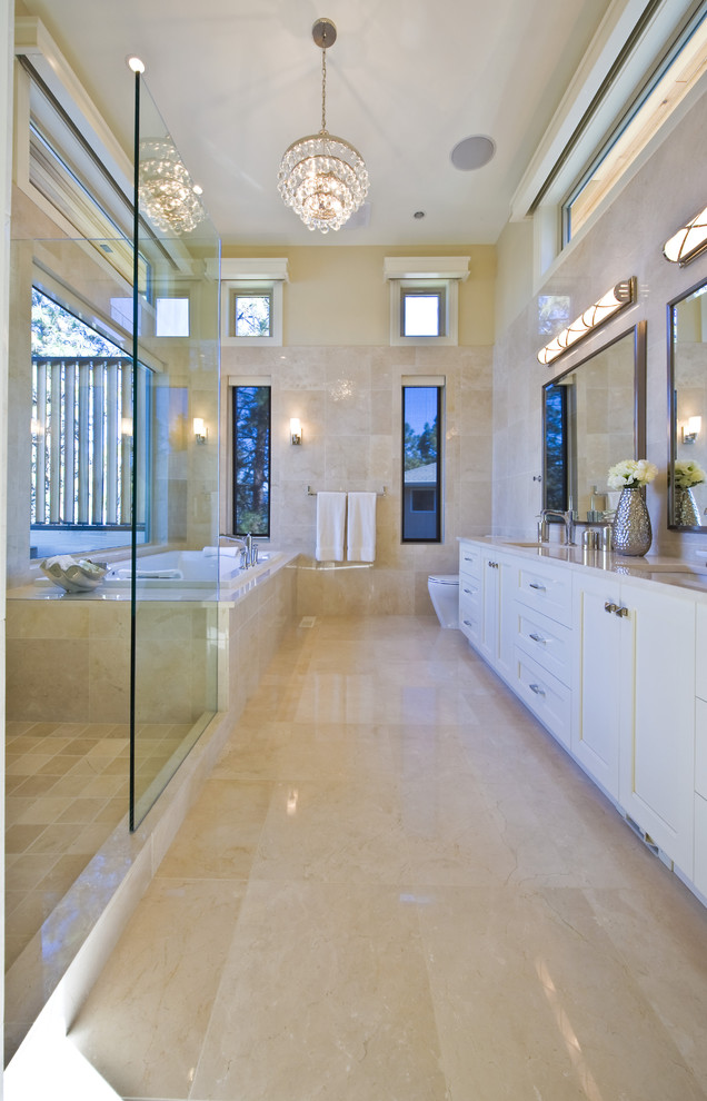 Photo of a contemporary bathroom in Vancouver with a submerged sink, white cabinets, a built-in bath, beige tiles and beige floors.