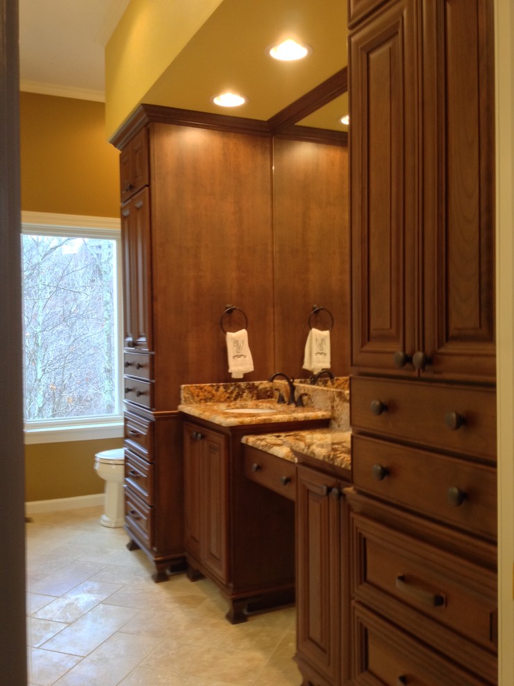 Bathroom - large traditional master beige tile and stone tile travertine floor bathroom idea in Charlotte with an undermount sink, furniture-like cabinets, medium tone wood cabinets, granite countertops, a two-piece toilet and beige walls