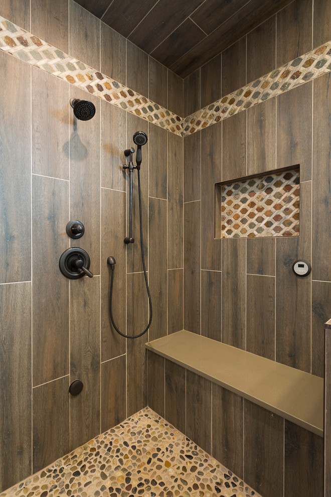Mid-sized mountain style master brown tile and porcelain tile porcelain tile and brown floor alcove shower photo in Denver with shaker cabinets, beige cabinets, beige walls, an undermount sink, quartz countertops, a hinged shower door and brown countertops