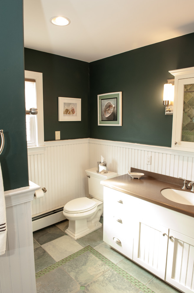 Example of a mid-sized classic master glass tile green floor bathroom design in Philadelphia with flat-panel cabinets, white cabinets, green walls, an integrated sink and a hinged shower door