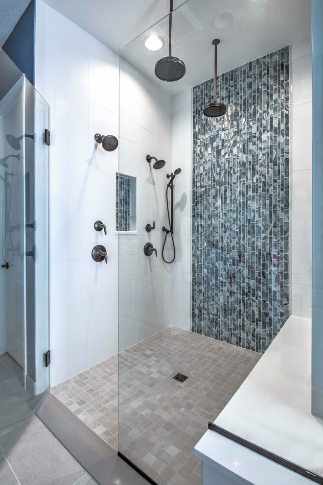 Foto på ett mellanstort funkis en-suite badrum, med en dusch i en alkov, blå kakel, glaskakel, blå väggar, beiget golv och dusch med gångjärnsdörr