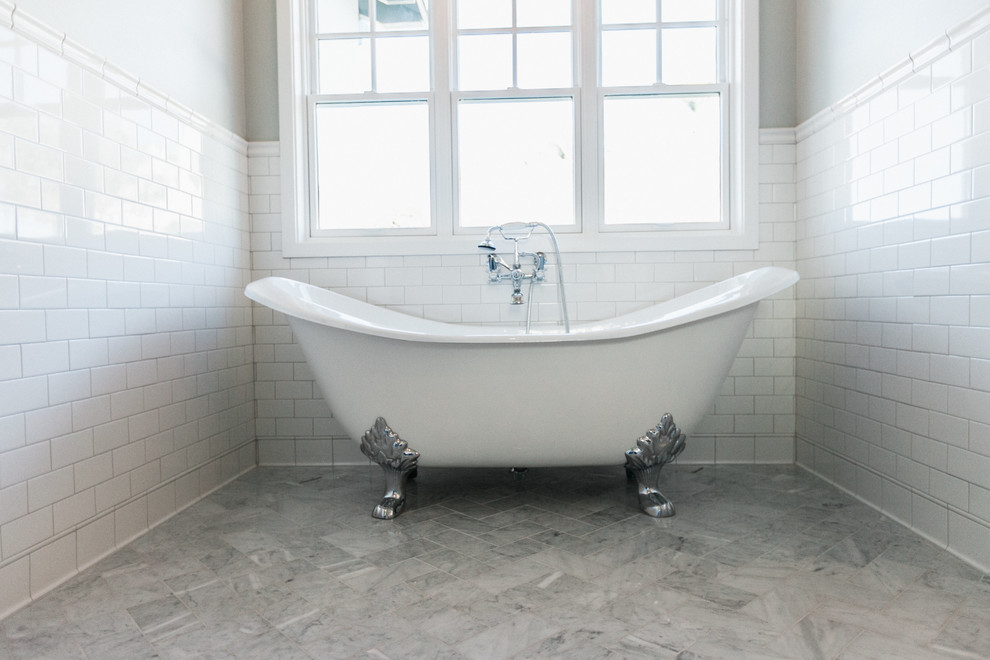 Modelo de cuarto de baño principal de tamaño medio con armarios estilo shaker, bañera con patas, paredes grises y suelo de mármol