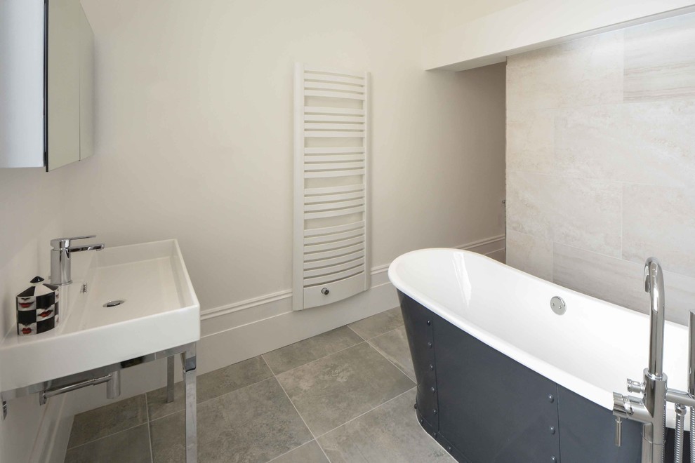Design ideas for a large contemporary ensuite bathroom in Kent with a trough sink, open cabinets, a freestanding bath, a walk-in shower, a wall mounted toilet, grey tiles, porcelain tiles, white walls and ceramic flooring.