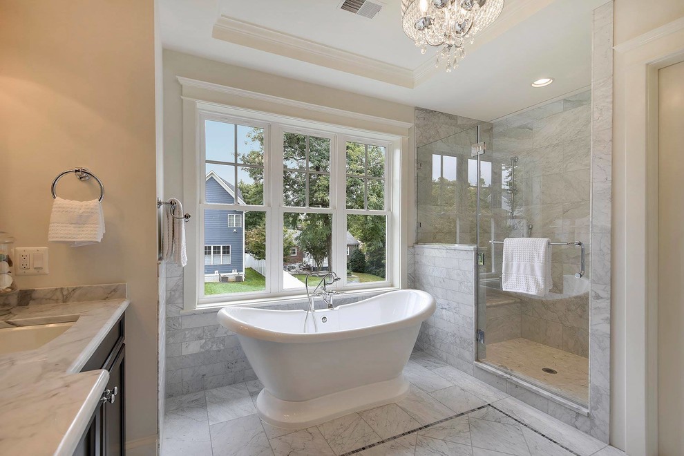 Inspiration for a mid-sized timeless master marble tile marble floor bathroom remodel in DC Metro with recessed-panel cabinets, brown cabinets, gray walls, an undermount sink and marble countertops