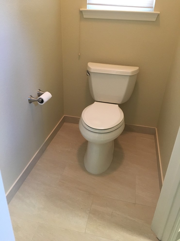 Mid-sized trendy porcelain tile and beige floor powder room photo in Austin with a two-piece toilet and beige walls