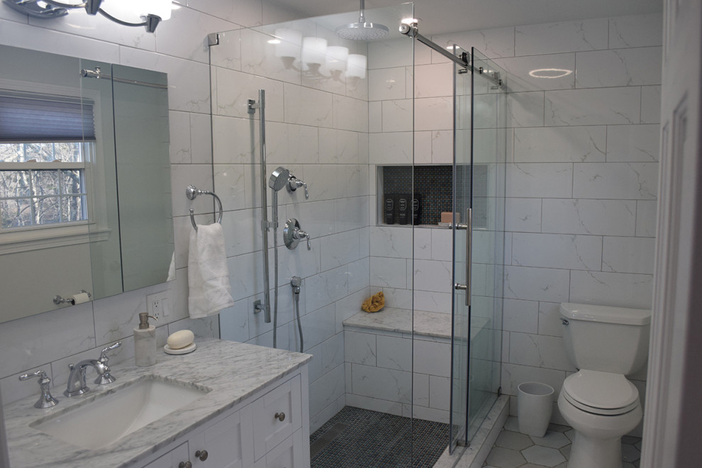 Example of a mid-sized trendy master white tile and porcelain tile porcelain tile and blue floor bathroom design in Boston with shaker cabinets, white cabinets, a two-piece toilet, gray walls, an undermount sink, marble countertops and white countertops