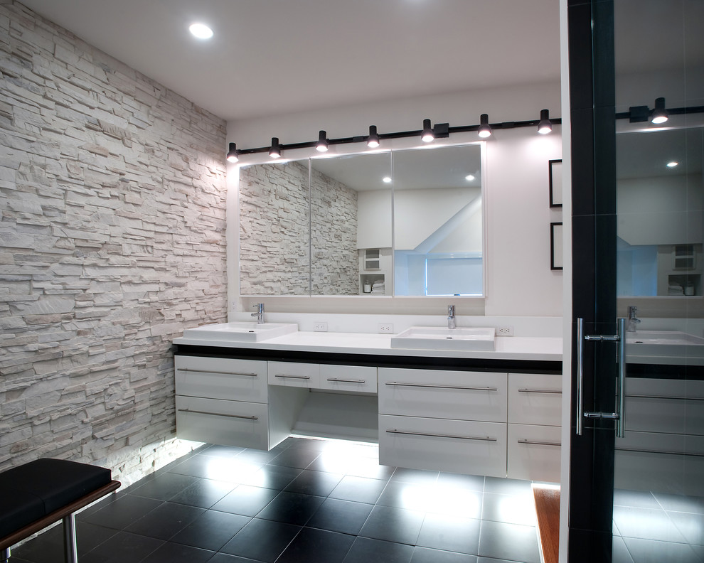 Example of a large minimalist master ceramic tile dark wood floor alcove shower design in New York with flat-panel cabinets, a two-piece toilet, white walls, an undermount sink, solid surface countertops and white cabinets
