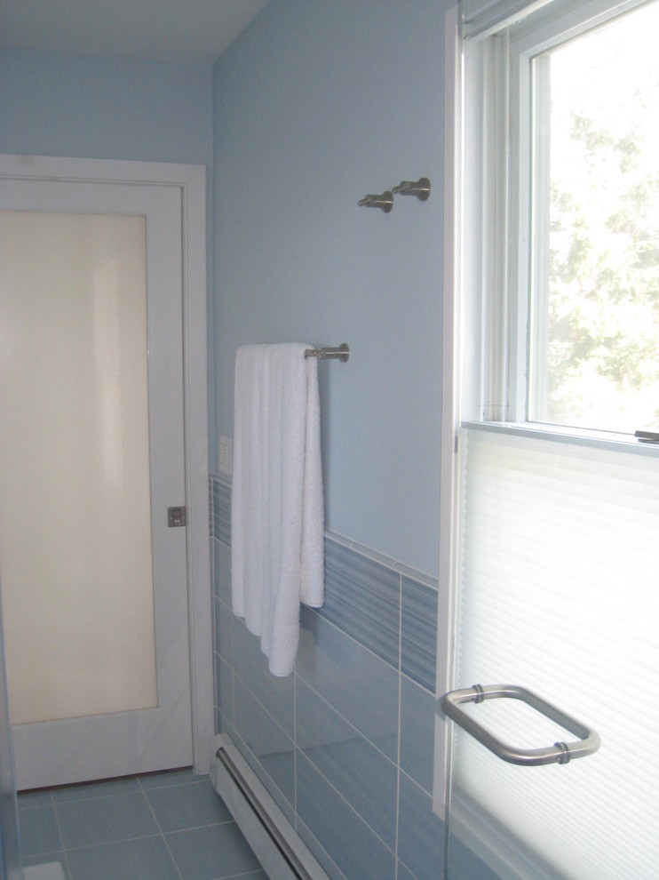 Example of a mid-sized minimalist 3/4 blue tile and porcelain tile porcelain tile double shower design in New York with flat-panel cabinets, white cabinets, a two-piece toilet, an undermount sink, blue walls and quartz countertops