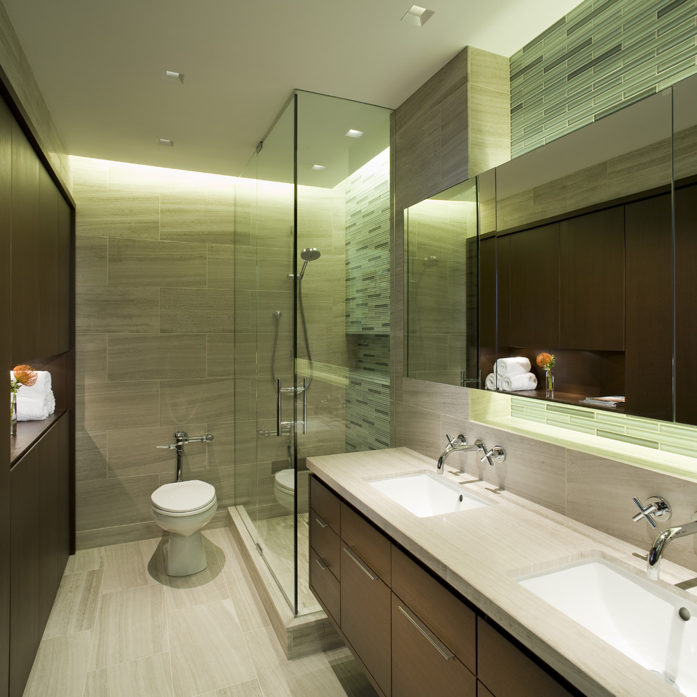 Photo of a contemporary ensuite bathroom in Chicago with a submerged sink, flat-panel cabinets, dark wood cabinets, a corner shower, a one-piece toilet, grey tiles and grey walls.