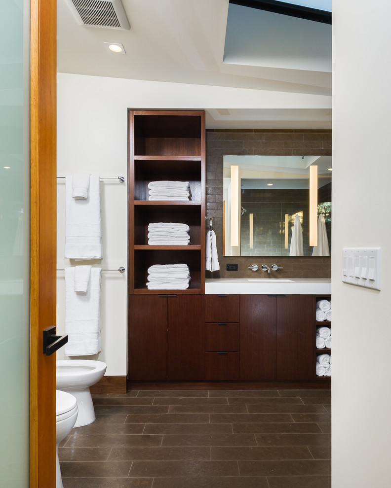 Inspiration for a mid-sized modern master brown tile and stone tile limestone floor walk-in shower remodel in Los Angeles with an undermount sink, flat-panel cabinets, dark wood cabinets, quartzite countertops, a bidet and white walls