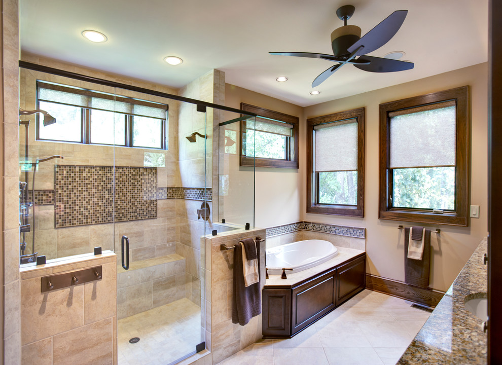 Large elegant master beige tile bathroom photo in Other with raised-panel cabinets, dark wood cabinets and beige walls